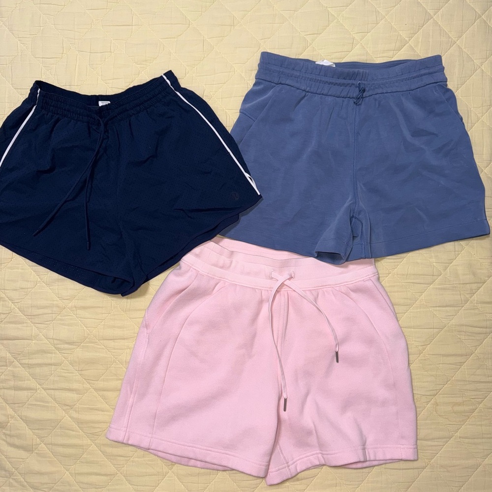 Lululemon Set of Three Casual Shorts - Navy size 4, Blue size 6, Pink size 6.